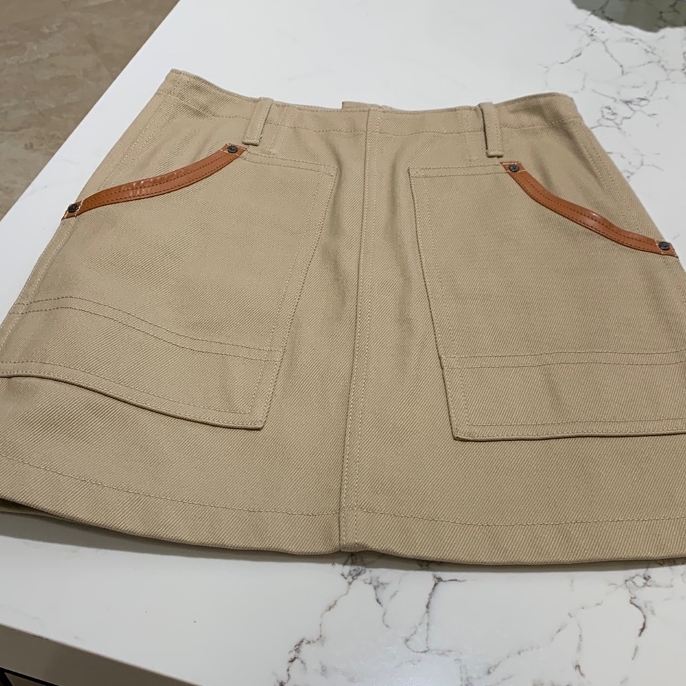Coach, mini skirt, genuine leather trim.